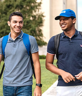 Two males walking outside of campus